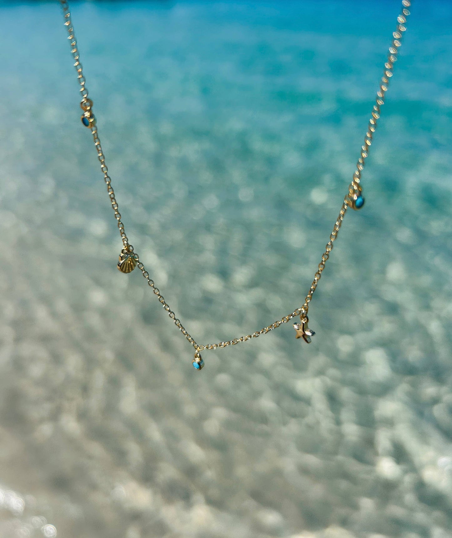 Shelling Charm Necklace: Gold Plated